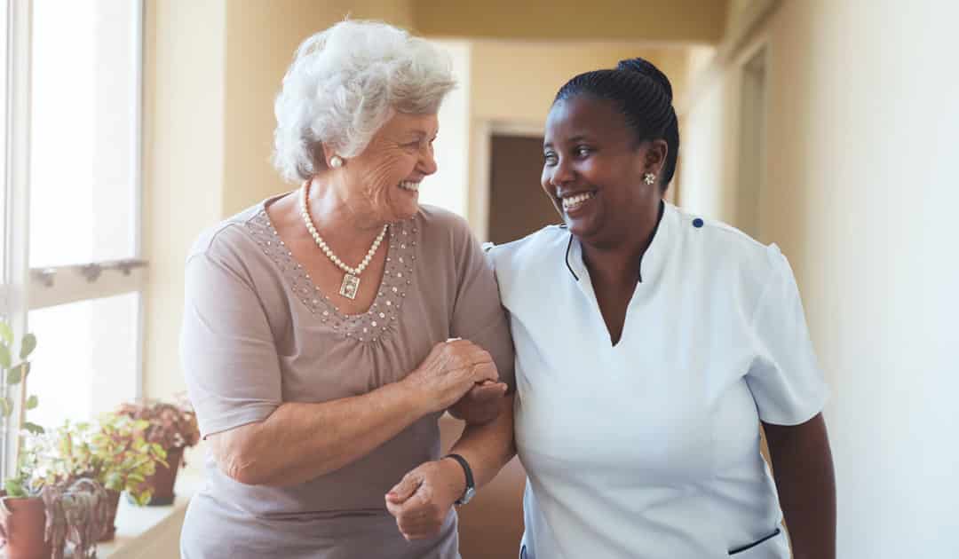 Continuing Care Retirement Community resident and staff walking together