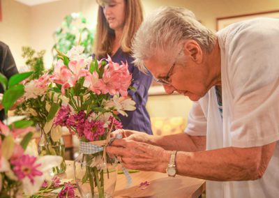 woman putting together a flower bouquet